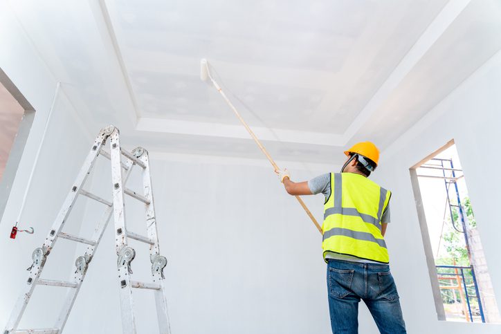 Man painting ceiling